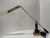 Vintage House of Troy counterbalance piano or desk lamp featuring polished brass-tone metal with dark wood accents. The...