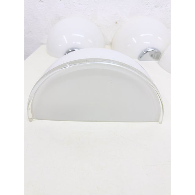 Four Artemide wall lamps, model Onfale Parete 28, designed in 1978 by Luciano Vistosi. These lamps date from the late...