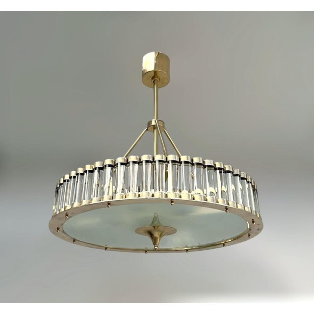 Italian art deco style drum chandelier with clear Murano glass rods mounted on solid brass frame in unlacquered natural...