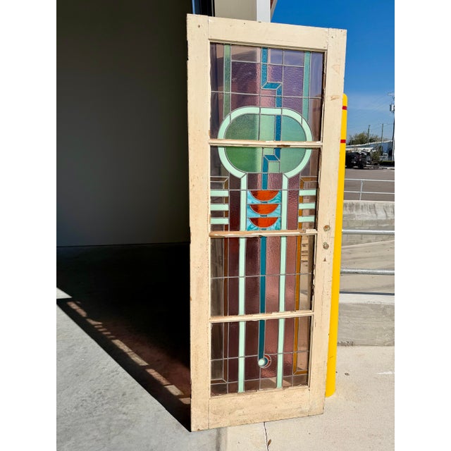 Stunning antique Art Deco stained glass door. Nicely detailed geometric design in blue, purple and green with red and...