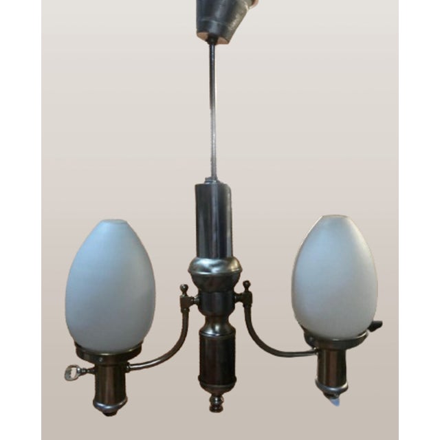 Introducing a beautiful ceiling lamp with two arms holding two egg-shaped matte opaline glass shades. This is a stunning...