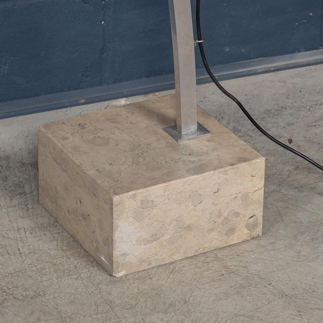 An elegant arc floor lamp from Italy, circa 1970s, featuring a harmonious blend of materials that exemplify timeless...