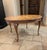 Round marquetry table featuring a marvelously detailed scene, "History of the World 1490-1590". The dates are inlaid on...