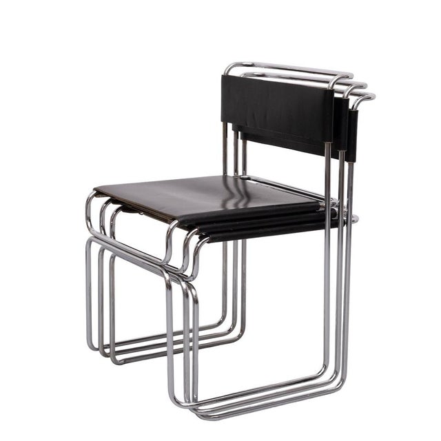 Elegant and unmistakably Bauhaus 'Libellula' Dining chairs composed of a chromed tubular steel frame on which rest a Black...