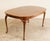A classic Queen Anne-style oval dining table by Hickory Chair Furniture Company, attributed to the James River Collection...