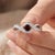 This elegant ring features a captivating Garnet gemstone, admired for its deep crimson glow and intense, fiery appeal....