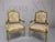Elegant pair of late 20th century Louis XVI–style armchairs featuring finely carved giltwood frames with refined...