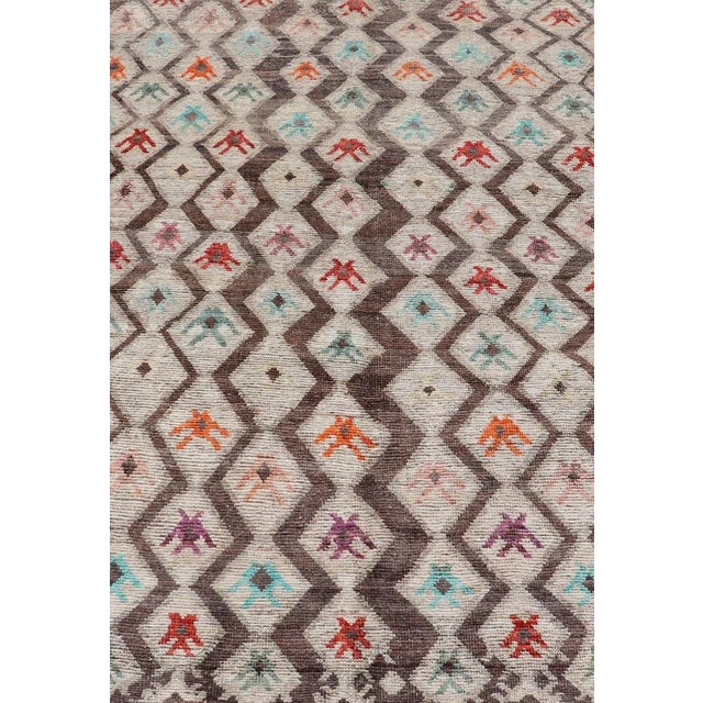 This modern casual tribal rug has been hand-knotted. The rug features a modern all-over sub-geometric diamond design,...