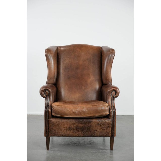 We are offering this warm, cozy, and comfortable vintage sheepskin wing chair with character. We believe that no interior...