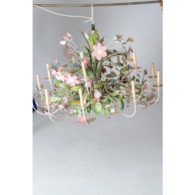 A one of a kind, custom made huge metal floral chandelier with multiple variety of flowers. A whimsical, playful massive...