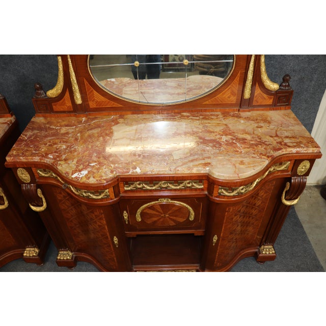 This highly decorative and imposing pair of sideboards (or buffets) is a spectacular example of high-end Rococo Revival...