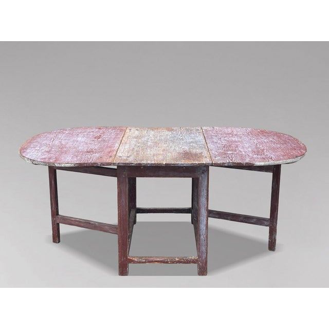 A Charming Early 19th-Century Swedish Painted Pine Slagbord Drop-Leaf Dining Table, Sweden, circa 1810 This delightful...