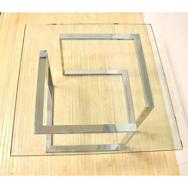 A square modernist open-frame design with clean lines, this square coffee table has 2 sections of chrome plated steel...
