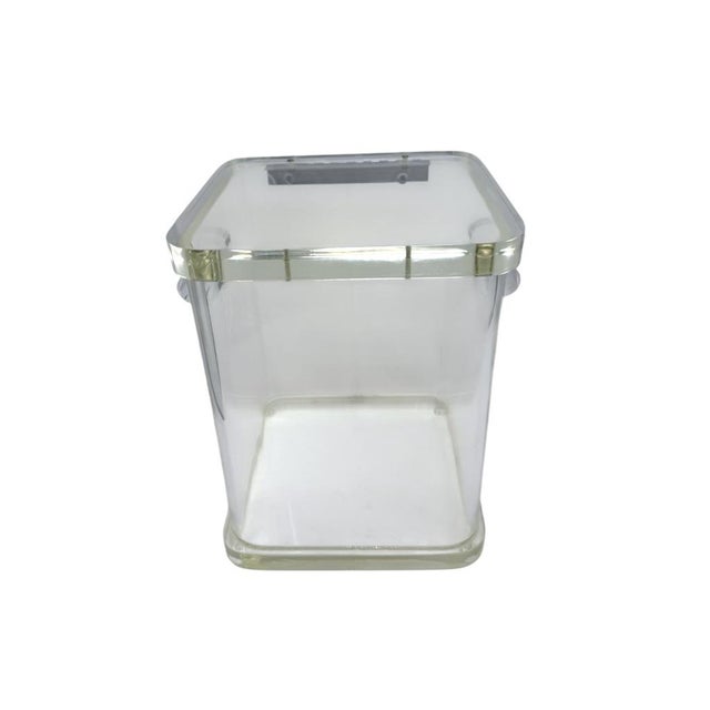 Durable lucite ice bucket with a sleek, transparent design and hinged lid for easy access. Chrome hinge accents add...