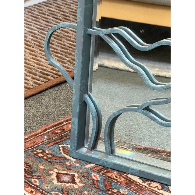 Design Plus Gallery presents a Postmodern Patinated Abstract Wave Wall Mirror. This rectangular mirror is framed in metal...