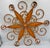 Timeless elegance and rustic charm to your living space with this beautiful French Country Wrought Iron Orange Starburst...