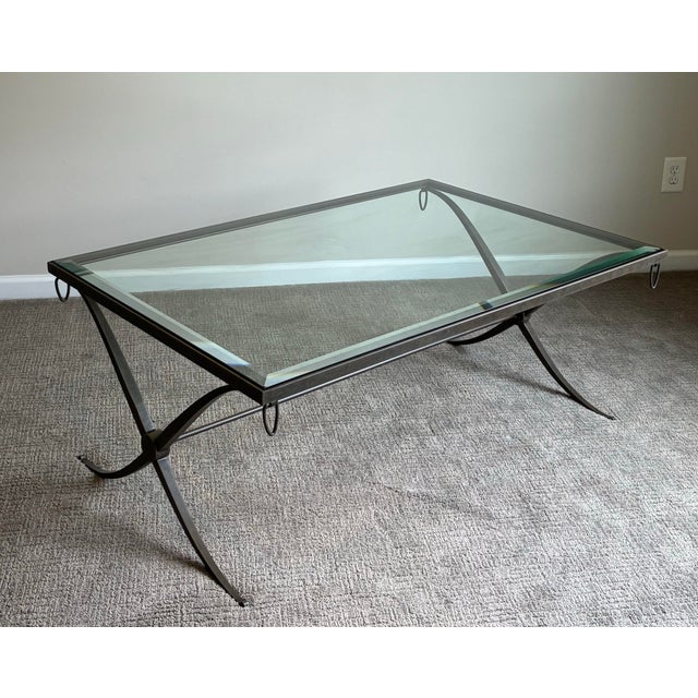 Elegant designer cocktail table by Barbara Barry for Baker Furniture featuring a refined hand-forged iron base with...