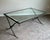 Elegant designer cocktail table by Barbara Barry for Baker Furniture featuring a refined hand-forged iron base with...