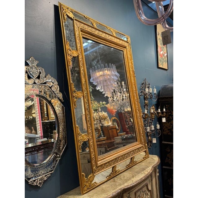Large Impressive 19th century Italian carved and giltwood cushion mirror. A 19th‑century Italian carved and giltwood...