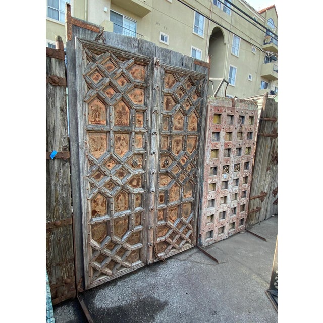 Amazing antique Indian haveli doors handcrafted from solid hardwood and clad with hand-forged iron detailing, dating...