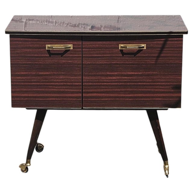 Mid-Century Modern Formica Bar Cart from the 60s Handmade mobile Bar - in Mahogany-Style Formica, which has a slightly...