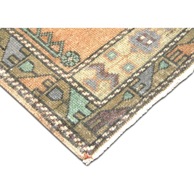A compact hand-woven wool yastic from Turkey's Oushak region, sized 1'9" x 3'. This vintage piece displays the hallmark...