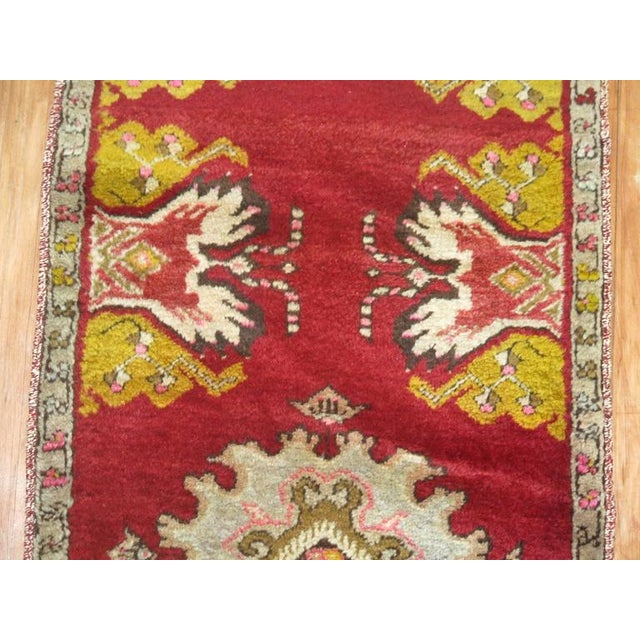 A narrow vintage turkish runner in predominant bright cherry red. 1'6'' x 10'3''