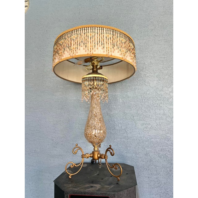 This ornate piece is a Early 20th Century Art Deco /Gatsby style table lamp. a design popular for its "glitz and glamour"...