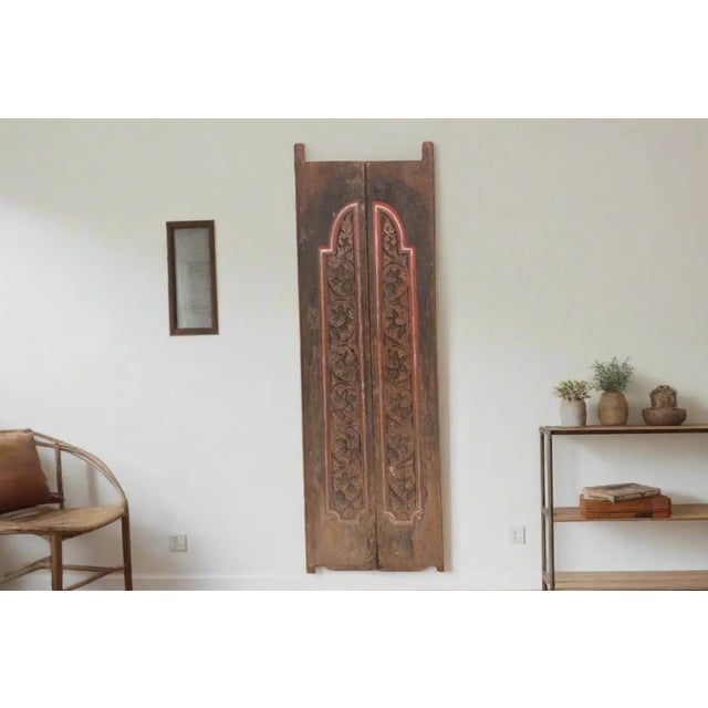 A rare primitive pair of ancient doors from Thailand. This set of two antique entrance doors feature an elaborate carved...