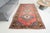 This is a vintage Turkish Oushak rug from the Mid 20th Century. The piece was hand-knotted.