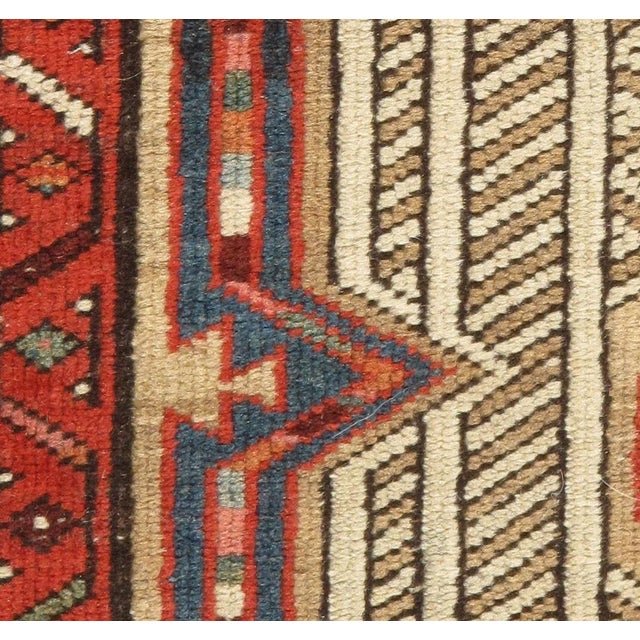 This small, circa 1920s handwoven runner is rich with intricate details, making it a true gem of craftsmanship.