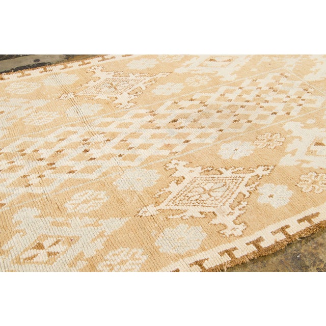 Hand-knotted in wool and originating circa 1950-1959, this 6x10 vintage Moroccan berber rug joins Rug & Kilim’s Moroccan...