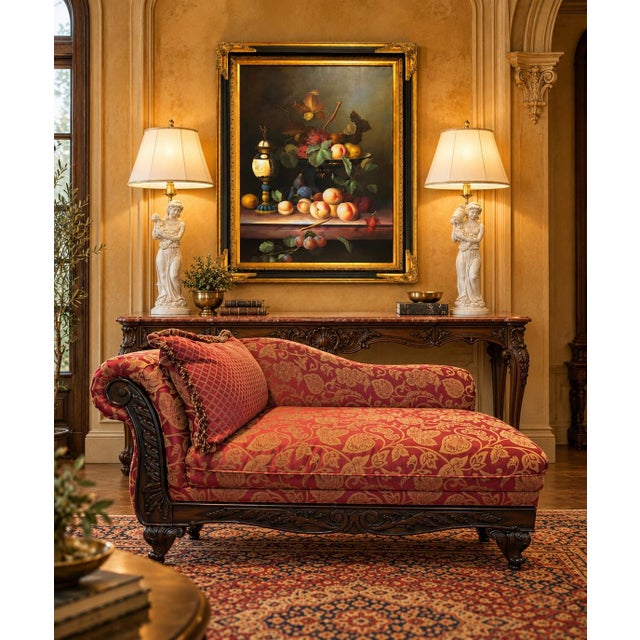 Elegant traditional chaise lounge featuring a richly carved mahogany frame with scrolling arm, acanthus leaf carvings, and...