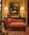 Elegant traditional chaise lounge featuring a richly carved mahogany frame with scrolling arm, acanthus leaf carvings, and...