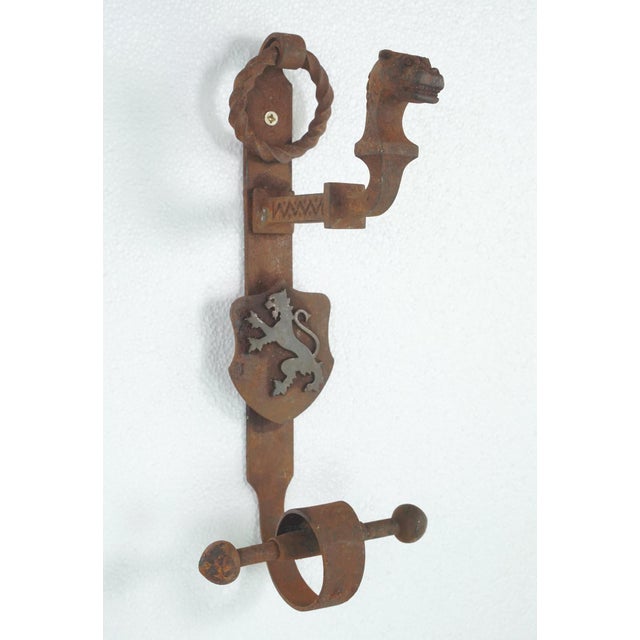 Antique Gothic grand double door wrought iron door pulls with central steel shields and knockers. The left shield displays...