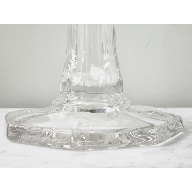 Elegant mid-century modern clear glass vase featuring a tall, sculptural swung form and flared scalloped rim. The...