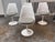Design Plus Gallery presents a Set of Four Tulip Armless Chairs Model 151C by Eero Saarinen from Knoll Studio. Originally...