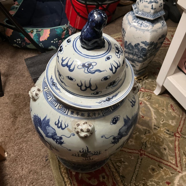 Striking large blue and white porcelain temple jar featuring detailed dragon motifs, decorative Chinese-style script, and...