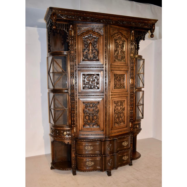 Late 19th century English cloak cupboard made from oak. This piece is exquisitely carved in great detail. The crown is...