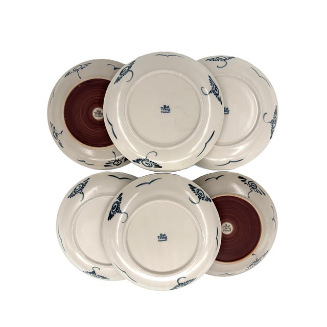 A beautifully collected set of six vintage Bat Trang dinner plates, combining two complementary blue-and-white patterns...