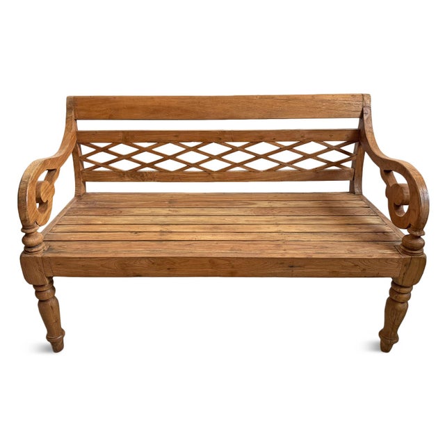 Vintage carved teak wood bench with diamond patterned back and beautifully carved arms and legs. Warm honey finish which...
