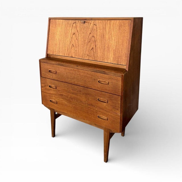 A beautifully proportioned mid-century Danish teak writing bureau, combining clean Scandinavian lines with practical...