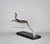 An elegant Art Deco sculpture features a chromed metal leaping gazelle mounted on a black marble base. It is made in a...