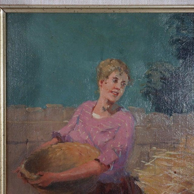 An evocative antique oil on board painting, dating to circa 1900, depicts a vibrant genre scene of a peasant woman. The...
