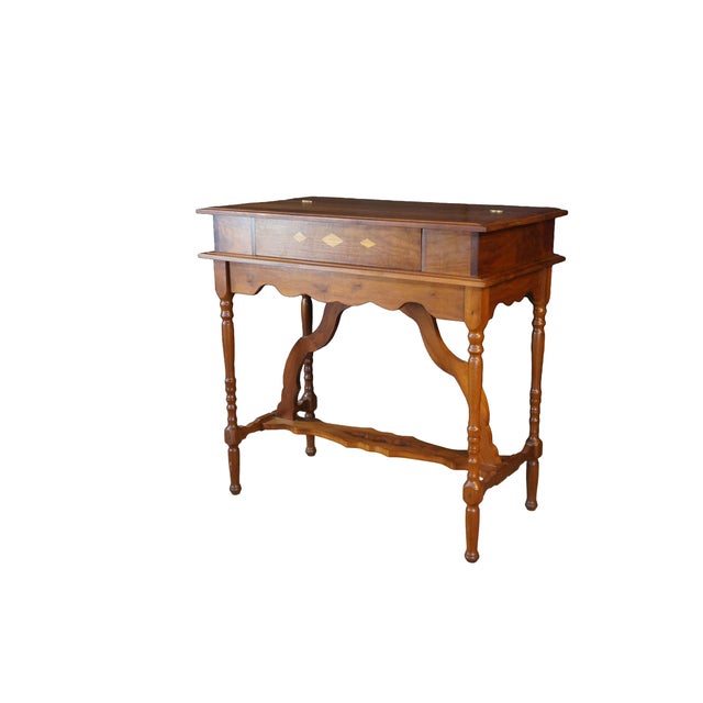 This Arts and Crafts style desk is crafted from solid walnut, showcasing a rich, warm brown finish and prominent, natural...
