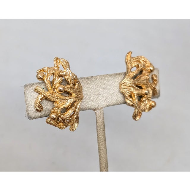 Circa 1972-4 goldtone coral with bumps textured clip and adjustable screw back earrings. Marked "NAPIER©" on the clips....