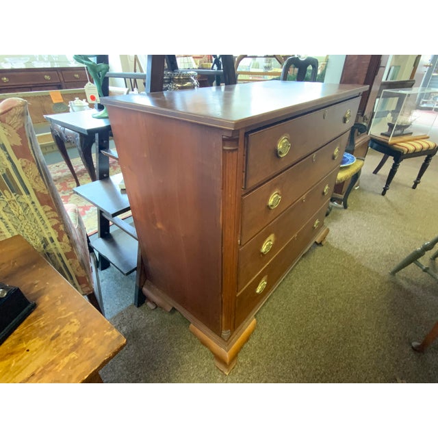 Early 19th century cherry wood chest of drawers. Brass pulls with eagle design, eschuns. Wood has column detail front...