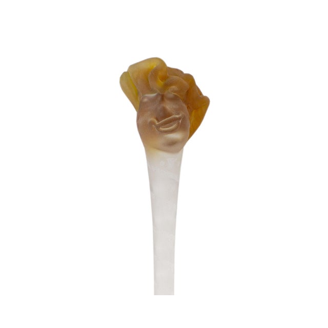 An art glass scepter sculpture by the American artist Stephen Fellerman. The piece is topped with a head with orange hair...