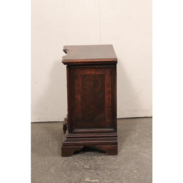 A heavily molded wood Italian three drawer side chest from the 19th century. This small-sized chest from Italy has a...