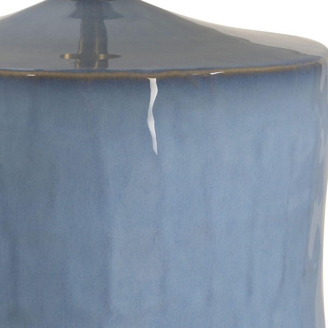 A refined blend of relaxed coastal style and artisanal character, this ceramic table lamp features a uniquely textured...